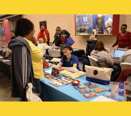 Agency representatives talk to people attending the volunteer expo