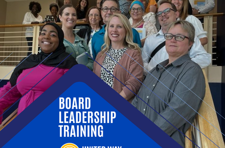 Board Leadership Training participants pose for a group photo on a staircase.