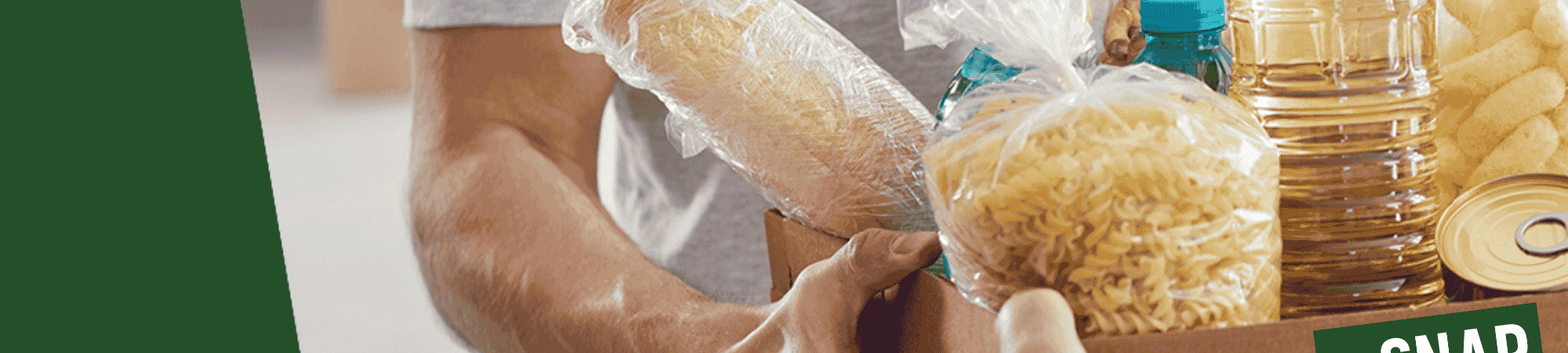 A volunteer handing over a box of food