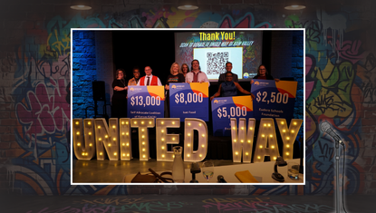 All the Grant Slam finalists pose on stage behind lighted letters that spell United Way.